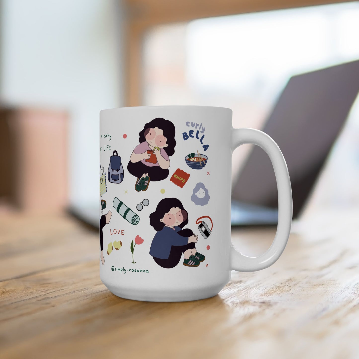 White mug with illustrations and text on a wooden surface